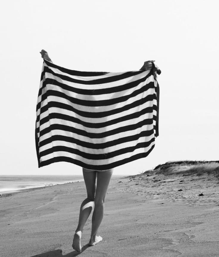 woman on beach with towel